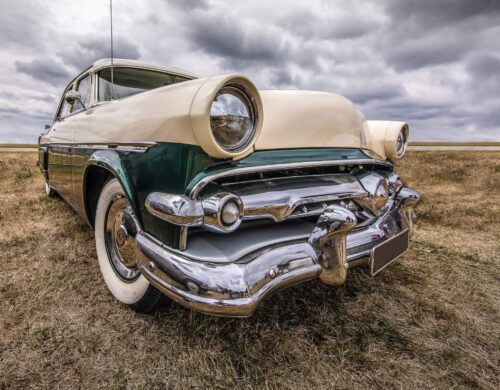 A closeup shot of a vehicle on a dry field under a cloudy sky