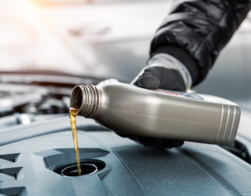 Close-up,Driver,Hand,Holding,Small,Bottle,Can,Pouring,Synthetic,Motor